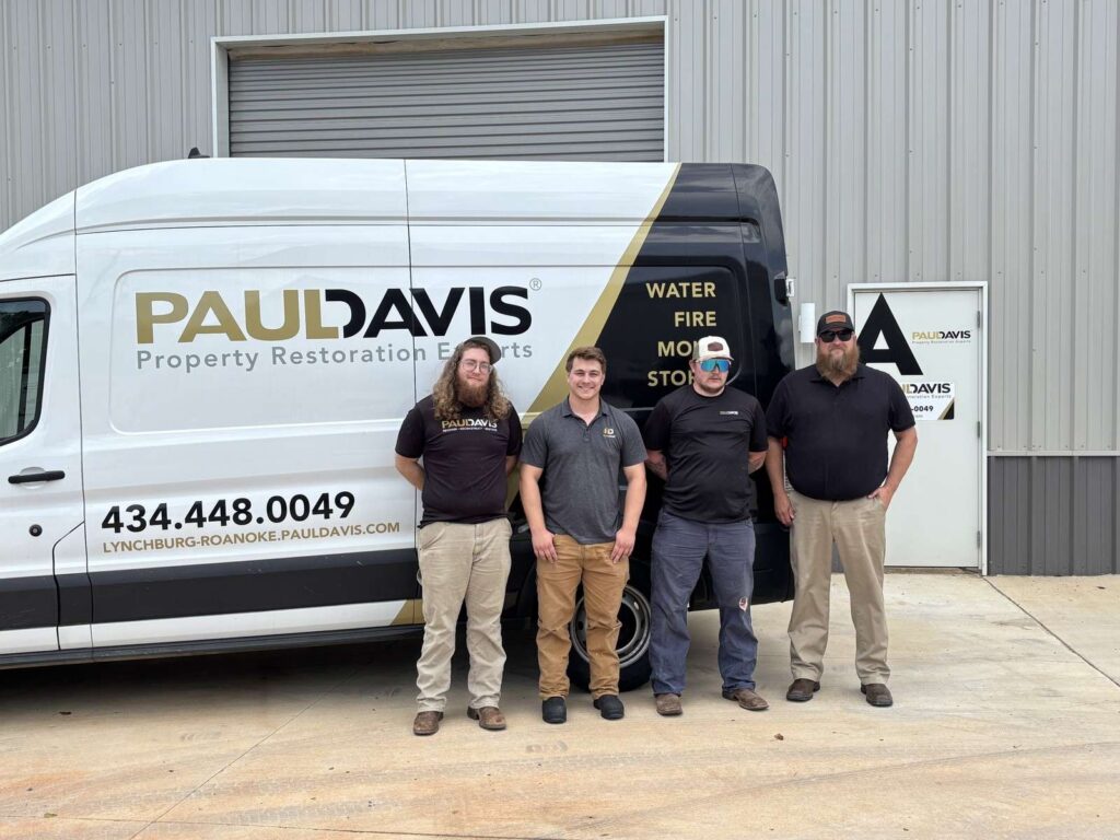 Paul Davis Restoration team standing in front of service van in Lynchburg, Roanoke and Southside VA